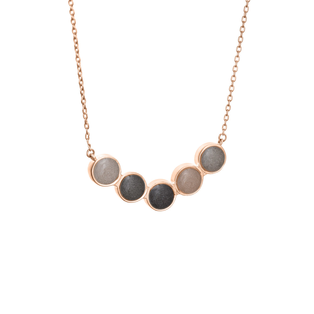 Pictured here is the Five Setting Chevron Cremated Remains Necklace in 14K Rose Gold and set with ashes by close by me jewelry from the side