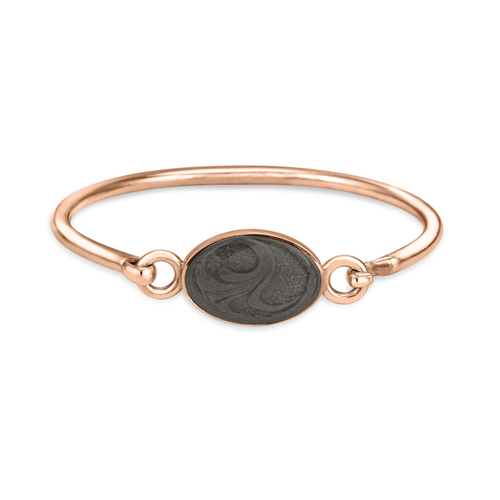 14k rose gold oval clasp cremation bracelet featuring solidified ashes shown from the front