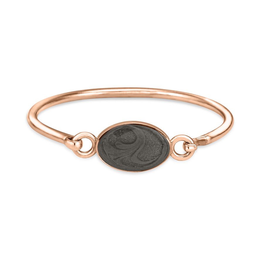 14k rose gold oval clasp cremation bracelet featuring solidified ashes shown from the front