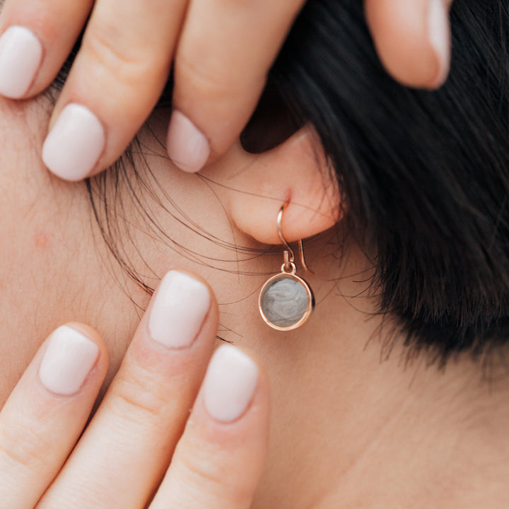 Simple dome cremation in 14k rose gold shown on model close up