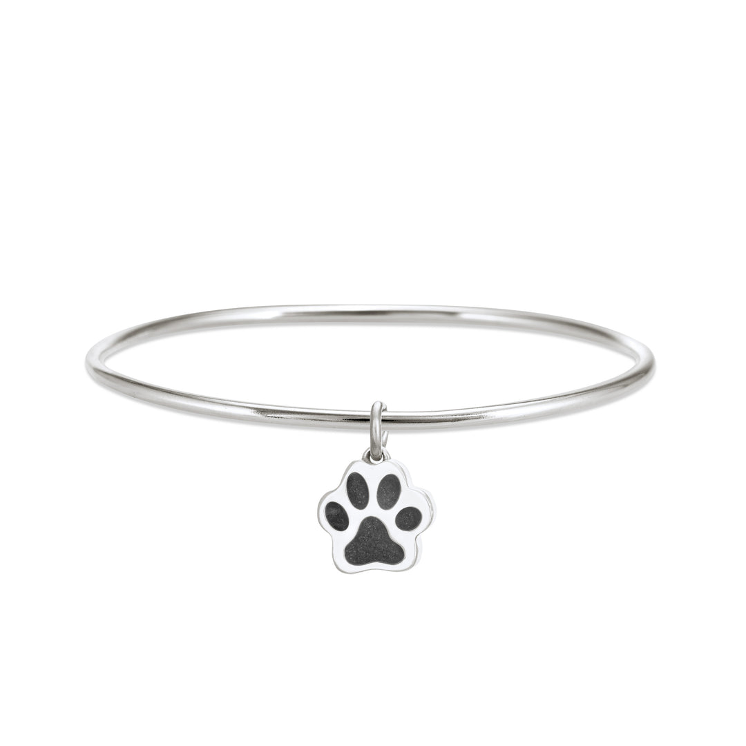 Sterling silver single bangle cremation bracelet with paw print ashes charm shown from the front