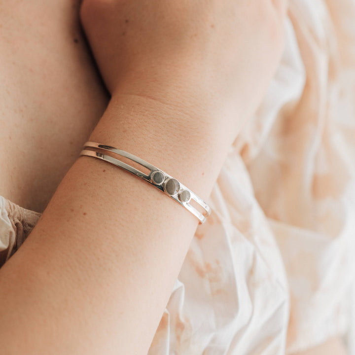 Three setting cremation cuff bracelet in sterling silver shown on model