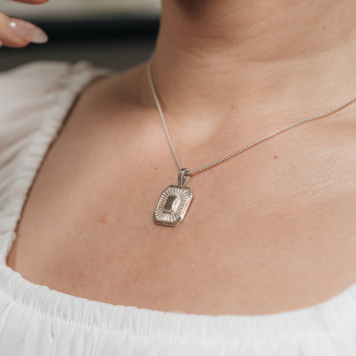 A close-up, cropped photograph of Close By Me's Tessa Cremation Necklace being worn around a woman's neck.