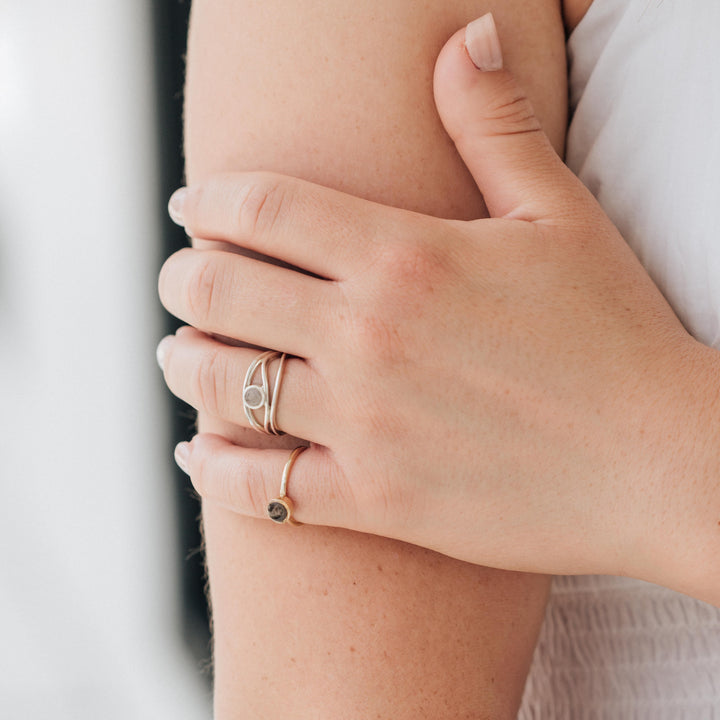 a ring with cremains being worn by a model in sterling silver in close by me's three band cremated remains ring design
