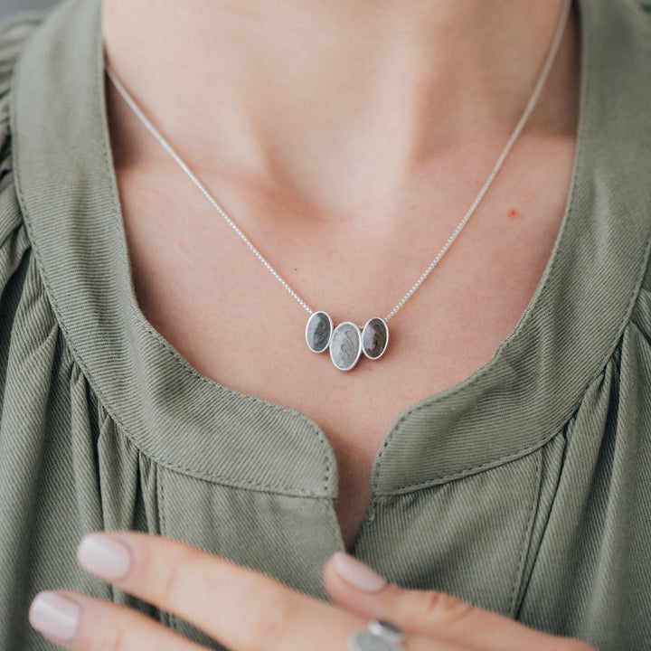 close by me jewelry's Triple Oval Setting Cremation Necklace in Sterling Silver being worn around a model's neck
