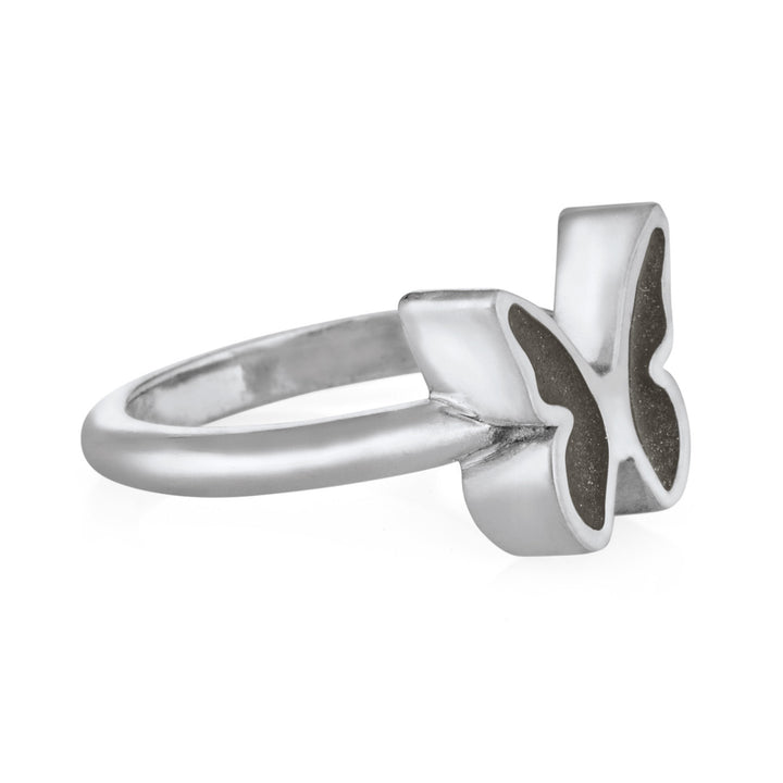 Pictured here is close by me jewelry's 14K White Gold Butterfly Cremation Ring design from the side to show its dark grey ashes setting and thickness of the bezel