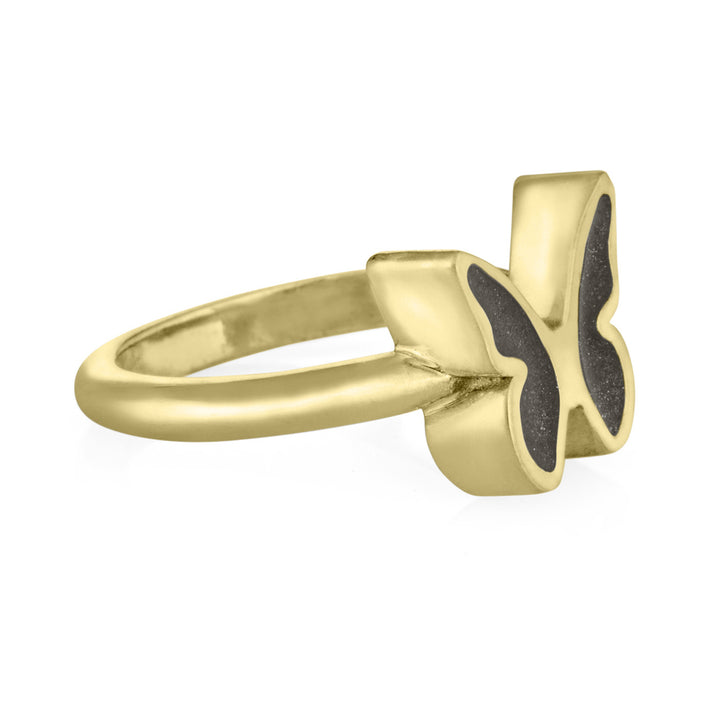 Pictured here is a 14K Yellow Gold Butterfly Ashes Ring Design by close by me jewelry from the side to show the dark gray setting in each wing and thickness of the bezel