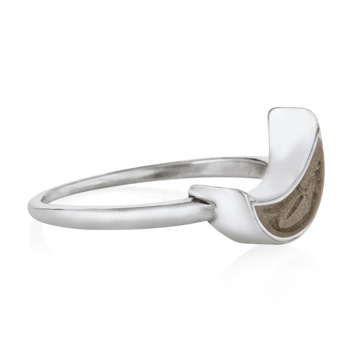 Pictured here is the Crescent Moon Ashes Ring design in 14K White Gold by close by me jewelry from the side to show its light brown cremation setting and thickness of its bezel