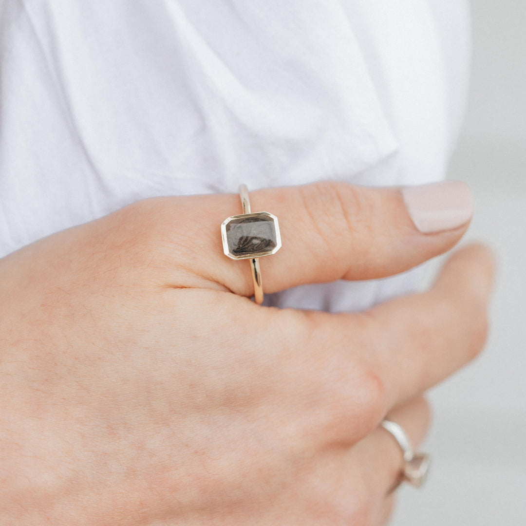 This photo shows a model wearing the 14K Yellow Gold Cushion Art Deco Ring by close by me jewelry on her thumb