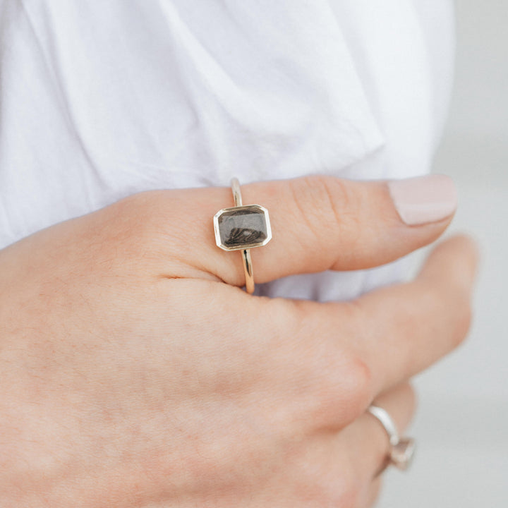 This photo shows a model wearing the 14K Yellow Gold Cushion Art Deco Ring by close by me jewelry on her thumb