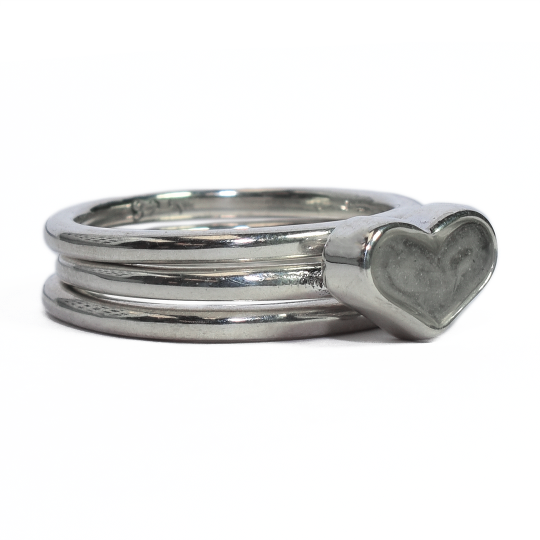Pictured here is the Sterling Silver Heart Ashes Stacking Ring Set designed and set with cremains by close by me jewelry from the front at an angle to the right