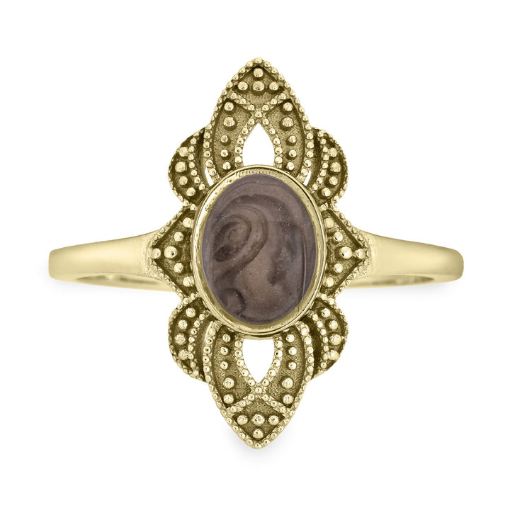 Pictured here is a close-up front view of Close By Me Jewelry's vintage-style World War II Cremation Ring in 14K Yellow Gold set against a solid white background. This version of the ring has a larger oval bezel containing solidified cremated remains. The ashes setting in this photo is medium gray in color and features a distinct swirl pattern.