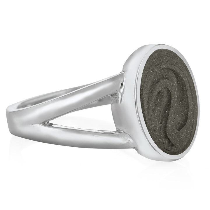 Pictured here is close by me jewelry's 14K White Gold Oval Split Shank Ashes Ring design from the side to show its medium grey cremation setting, thickness of its bezel, and split band