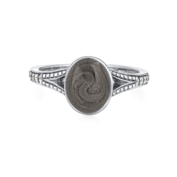 Pictured here is close by me jewelry's 14K White Gold Oval Split Shank White Diamond Band Ring design from the front to show its medium grey ashes setting and milgrain detail on the band