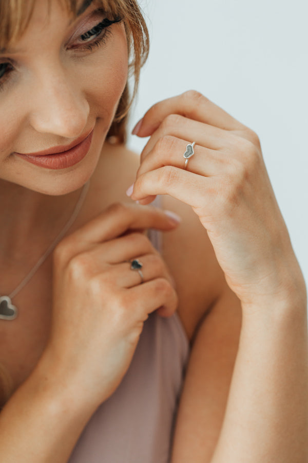 Pictured here is a model wearing close by me jewelry's Sterling Silver Small Heart Stacking Ring design on her ring finger