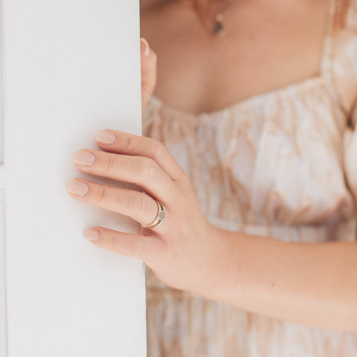 This photo shows the Twin Band Ring with cremains on a model's ring finger in Sterling Silver after being set with ashes by close by me jewelry
