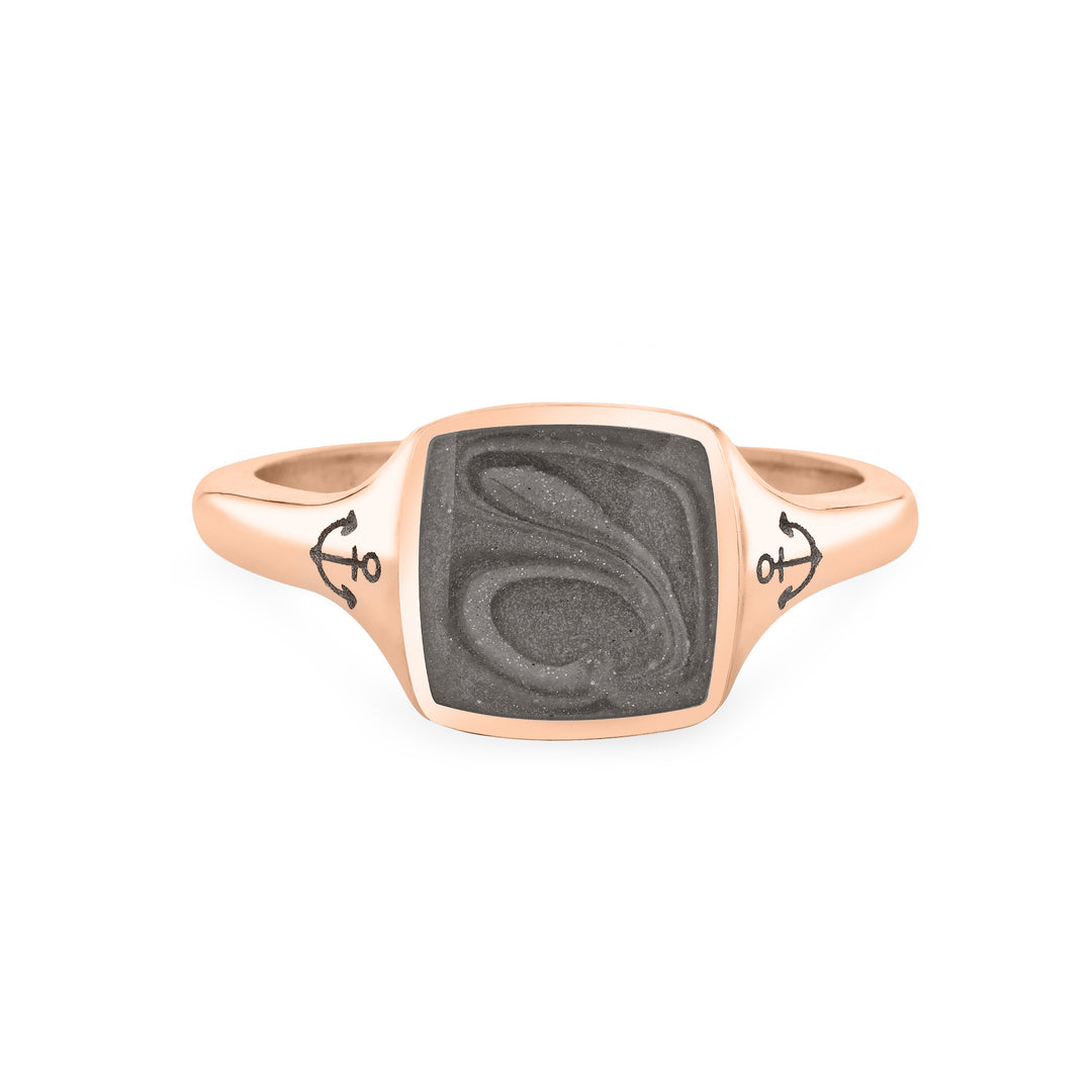 Close By Me's Anchor Signet Cremation Ring in 14K Rose Gold floats in the center of a solid white background, facing front. The square-shaped cremation setting is dark grey in color and has a bold, visible swirl. The anchor imprints in the band, on either side of the setting, are clearly visible.