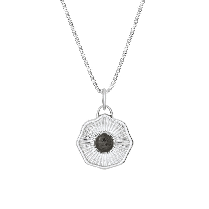 Front of Scalloped Coin "Aurea" Cremation Pendant in Sterling Silver on a chain against a white background.