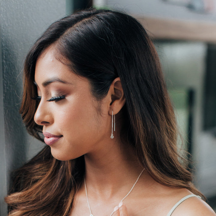   This voomed-out photo shows the side profile of a model wearing the Bilateral Chain Cremation Earrings designed by close by me jewelry in Sterling Silver