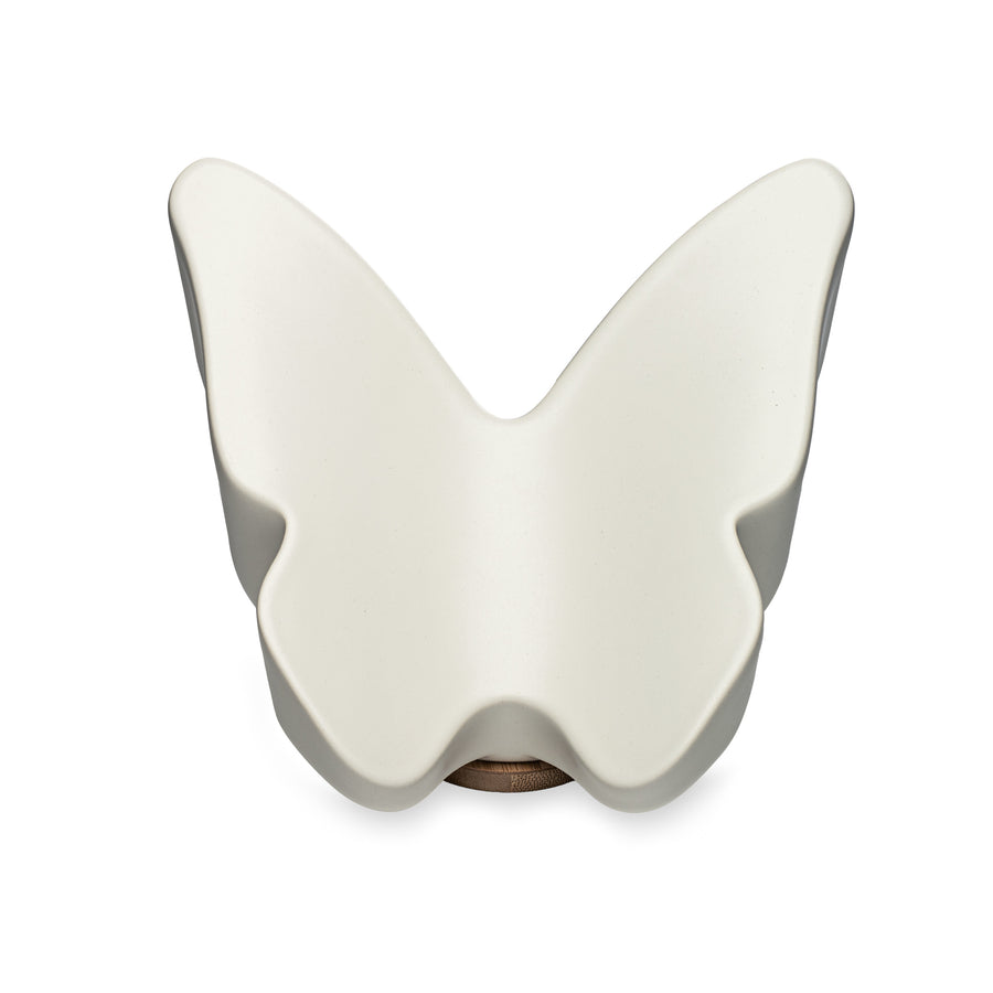 White butterfly-shaped ceramic urn on a white background