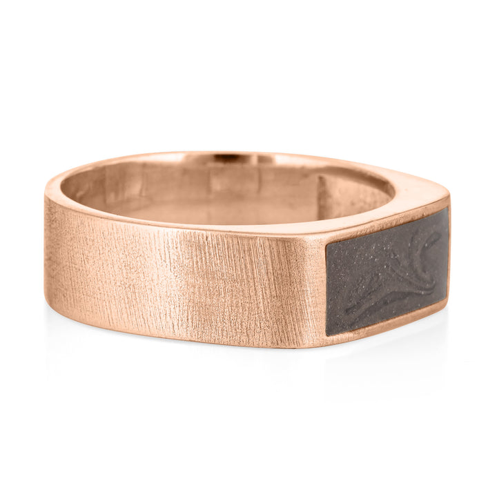 Pictured here is close by me jewelry's Men's Classic Band Cremation Ring design in 14K Rose Gold from theside to show its dark grey ashes setting and thickness of its brushed band