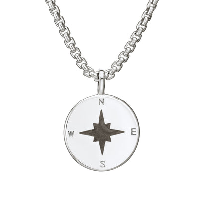 A close-up, front view of Close By Me's Compass Cremation Pendant in Sterling Silver, with a shiny finish, on a thick chain.