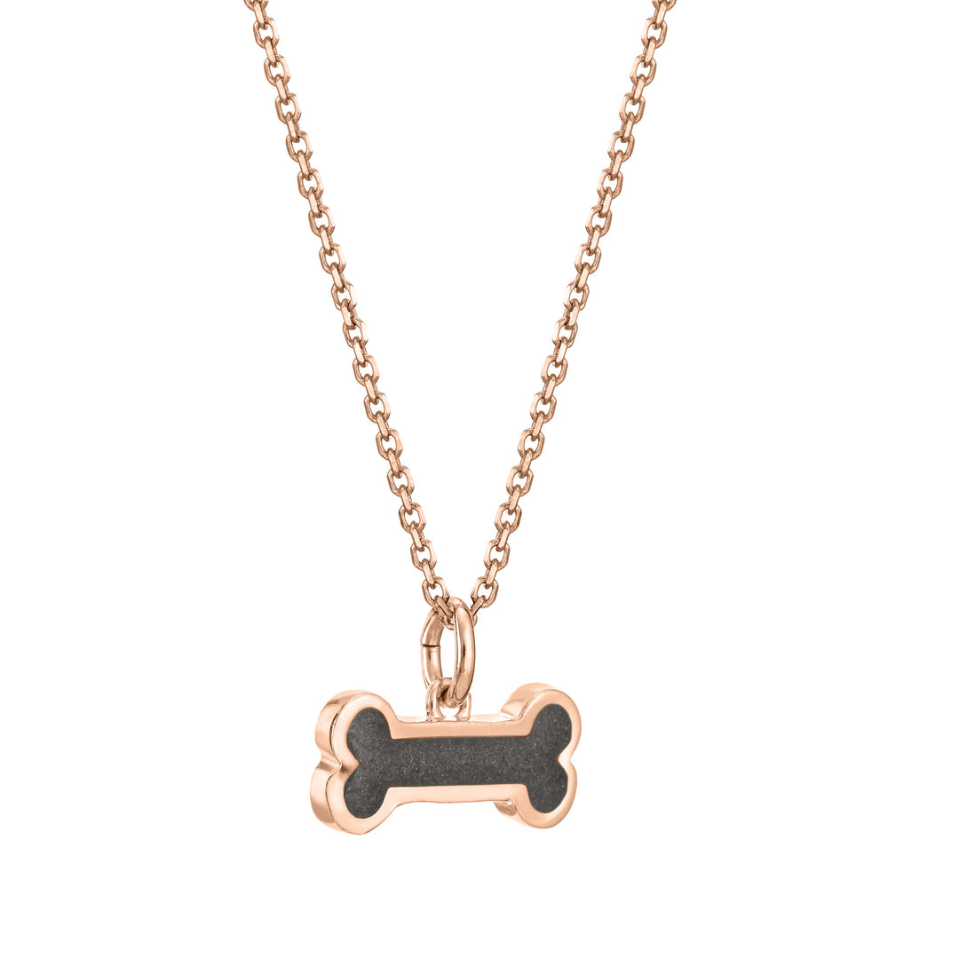 Pictured here is the Dog Bone Pendant with ashes in 14K Rose Gold, designed by close by me jewelry, from the side