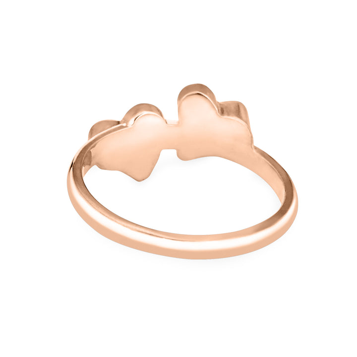 Back view of Close By Me's 14K Rose Gold Double Heart Cremation Ring, floating against a white backdrop.
