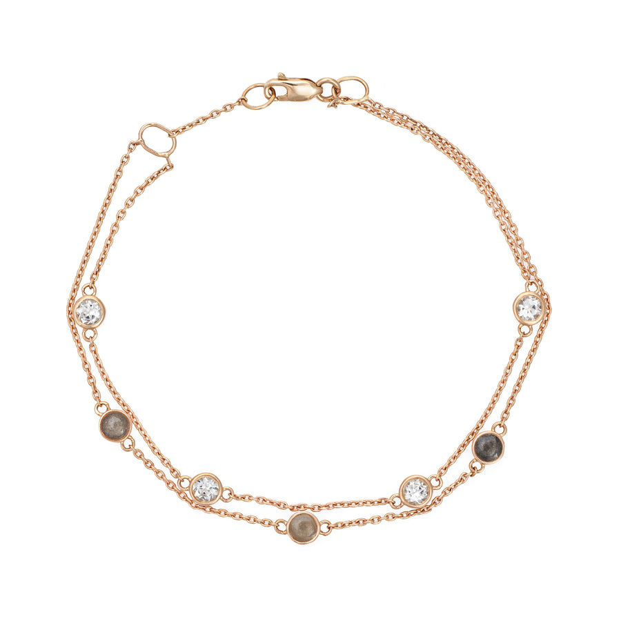 Close By Me's Double Strand Cremation Bracelet in 14K Rose Gold laid flat in a circular, closed position with the strand of four white topazes resting parallel atop the strand of three ash-filled charms.