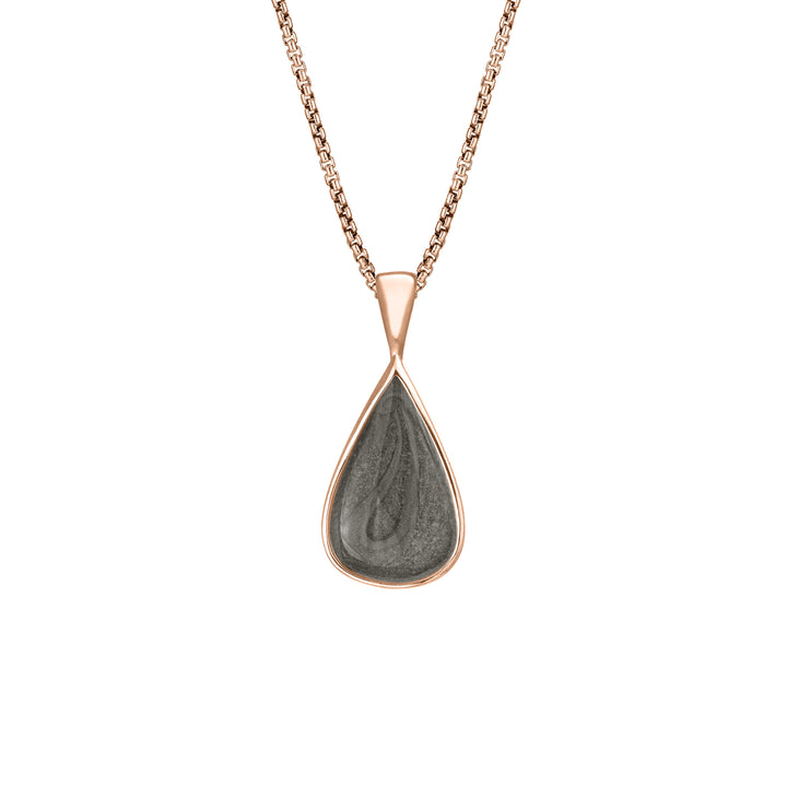 This photo shows the Fancy Bail Teardrop Pendant in 14K Rose Gold designed and set with ashes by close by me jewelry from the front