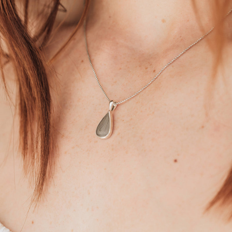 This close up photo shows a model with light skin wearing close by me jewelry&