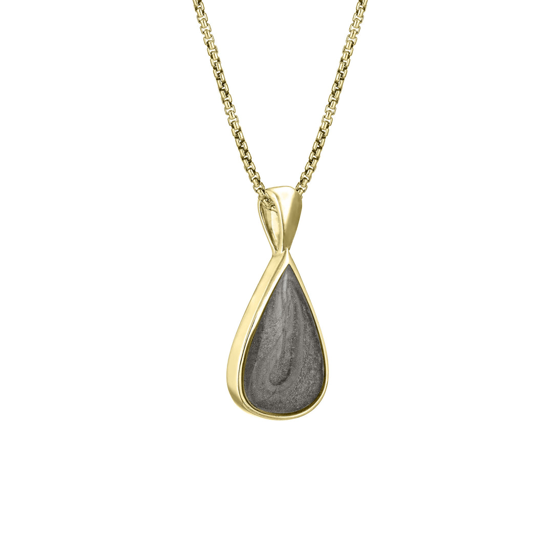 This photo shows the Fancy Bail Teardrop Cremation Pendant in 14K Yellow Gold designed and set with ashes by close by me jewelry from the side