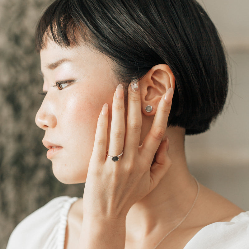 14k white gold hexagon stud ashes earrings pictured on a model 