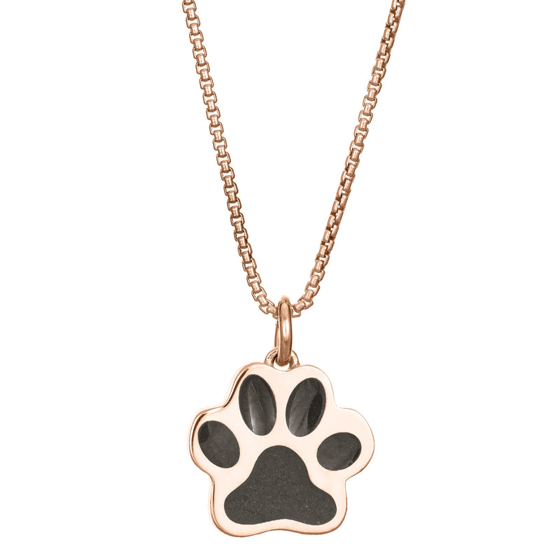 This photo shows the Large Paw Print Cremation Pendant design set with ashes in 14K Rose Gold by close by me jewelry from the front