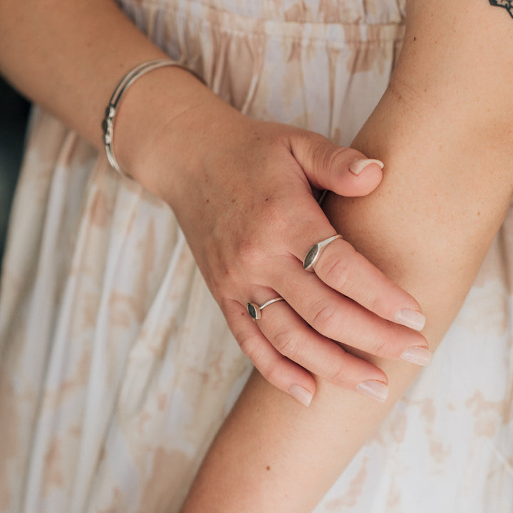 Pictured here is a model wearing close by me's Lateral Marquee Signet Ring design in Sterling Silver