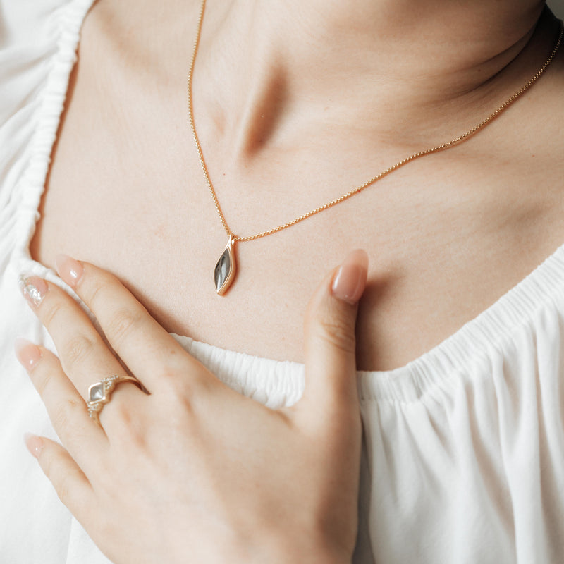 The Leaf Memorial Necklace design by close by me in 14K Rose Gold around a model in a white top&
