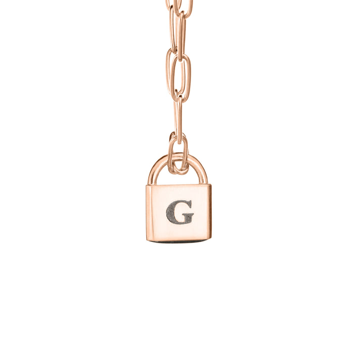 A Lock-style Cremation Necklace with a Stylized Chain with a capital "G" engraved on its front in 14K Rose Gold by close by me jewelry from the front