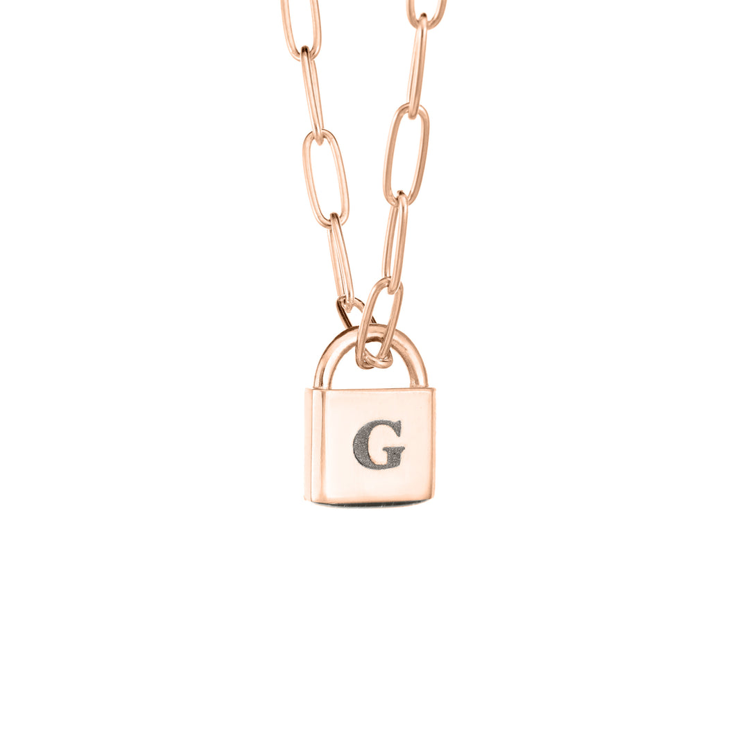 A Lock-style Cremation Necklace with a Stylized Chain with a capital "G" engraved on its front in 14K Rose Gold by close by me jewelry from the side