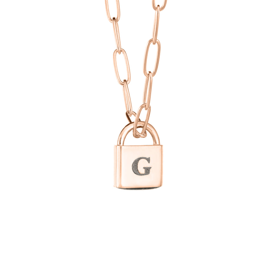 A Lock-style Cremation Necklace with a Stylized Chain with a capital "G" engraved on its front in 14K Rose Gold by close by me jewelry from the side