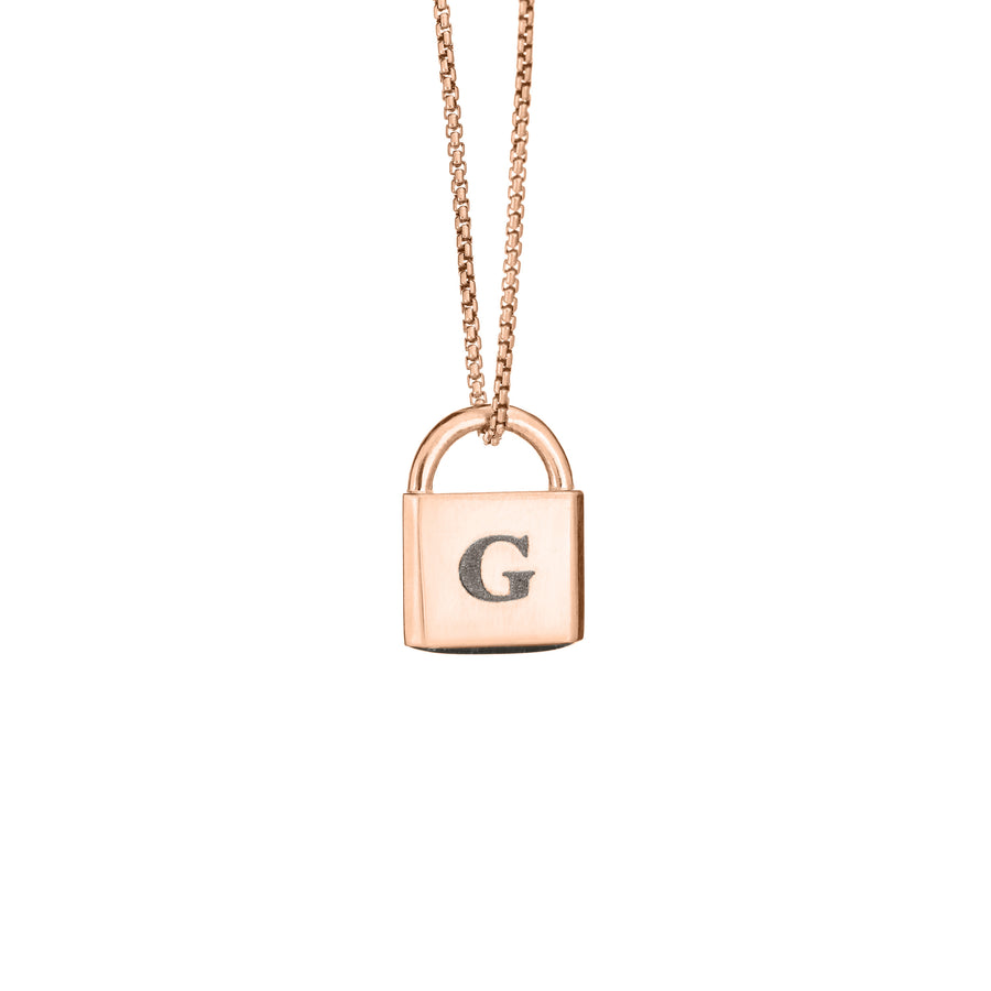 A Lock-style Cremation Pendant with a capital "G" engraved on its front in 14K Rose Gold by close by me jewelry from the front