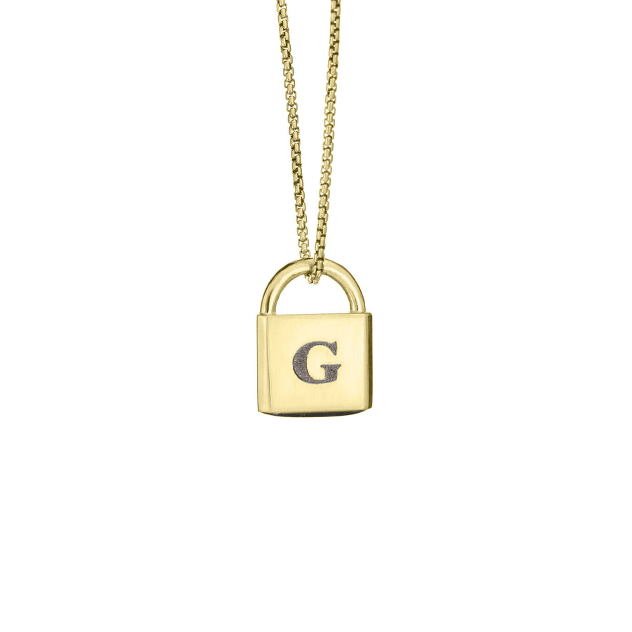 A Lock-style Cremation Pendant with a capital "G" engraved on its front in 14K Yellow Gold by close by me jewelry from the front