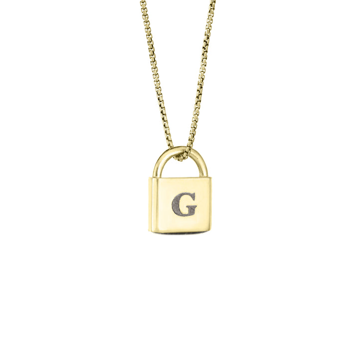 A Lock-style Cremation Pendant with a capital "G" engraved on its front in 14K Yellow Gold by close by me jewelry from the side
