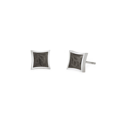 A pair of Close By Me's Luminary Stud Cremation Earrings in Sterling Silver set against a solid white background. A front view is shown for the left earring while the right earring is turned to show a side view.