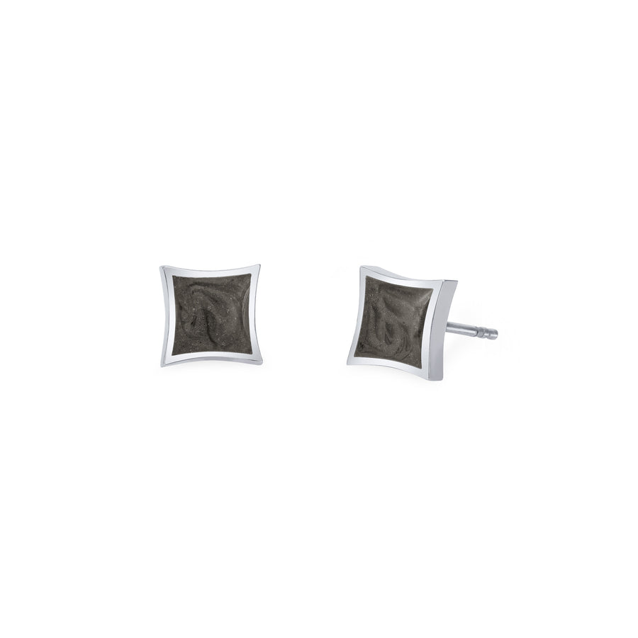 A pair of Close By Me's Luminary Stud Cremation Earrings in 14K White Gold set against a solid white background. A front view is shown for the left earring while the right earring is turned to show a side view.