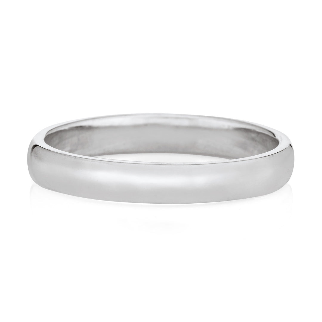 A memorial ashes ring with a simple design in 14k white gold on a white background