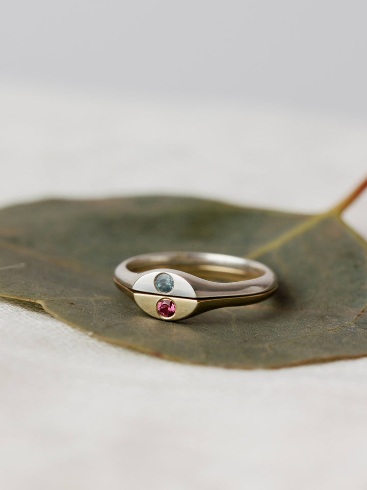 Close By Me's The Kindred Birthstone Rings on a leaf.