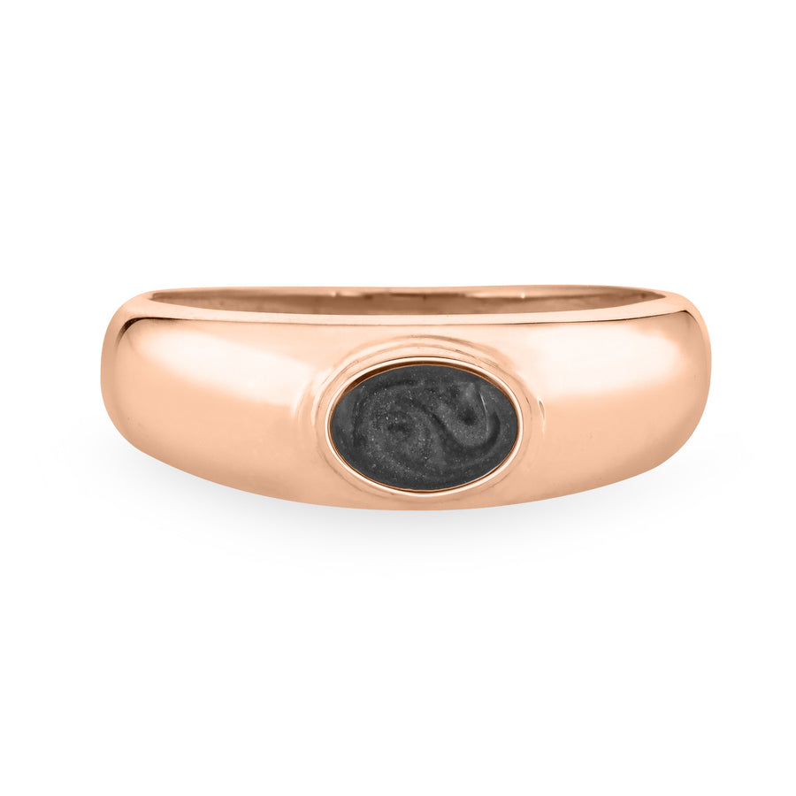 Centered against a stark white background, this 14K Rose Gold Oval Dome Cremation Ring from Close By Me Jewelry features an ashes setting that is dark grey in color with a subtle swirled pattern visible.