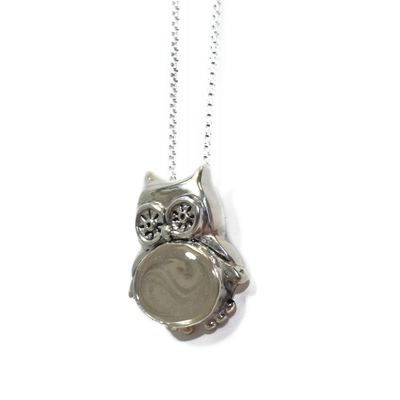 Pictured here is the Owl Cremation Pendant design in Sterling Silver, created and set with ashes by close by me jewelry, from a slight angle facing left