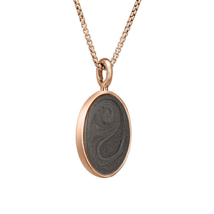 The simple bail oval pendant with ashes by close by me jewelry in 14k rose gold from the side