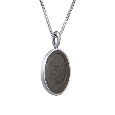 The simple bail oval pendant with cremated remains by close by me jewelry in 14k white gold from the side